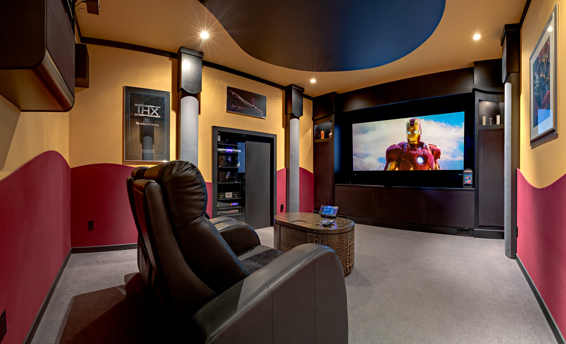 custom home theatre in Calgary with a starlight theater iron man theme and a curved masking screen.
