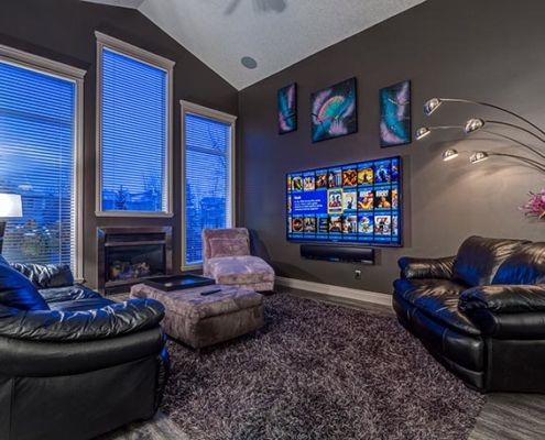 Large 8K flat panel TV on a Calgary home wall, perfect for the big game.