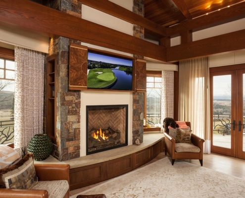 8K TV mounted above a fireplace in a luxury Calgary living room.