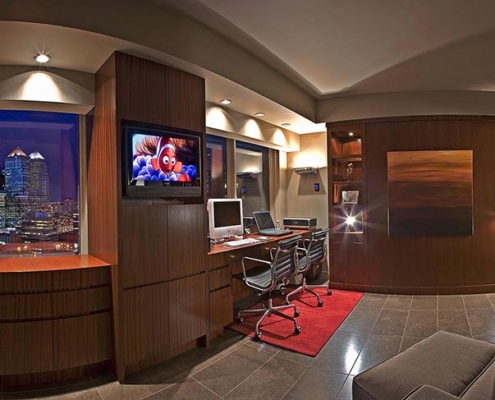 Sony 8K LED TV popping around the corner of an armoire in a Calgary residence.