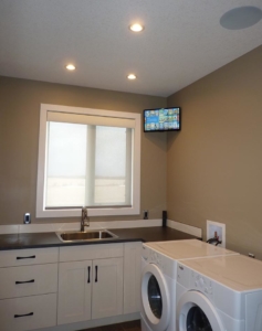 Calgary home's kitchen featuring an under-cabinet Samsung 8K TV installed by K&W Audio.