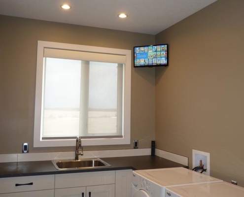 Calgary home's kitchen featuring an under-cabinet Samsung 8K TV installed by K&W Audio.